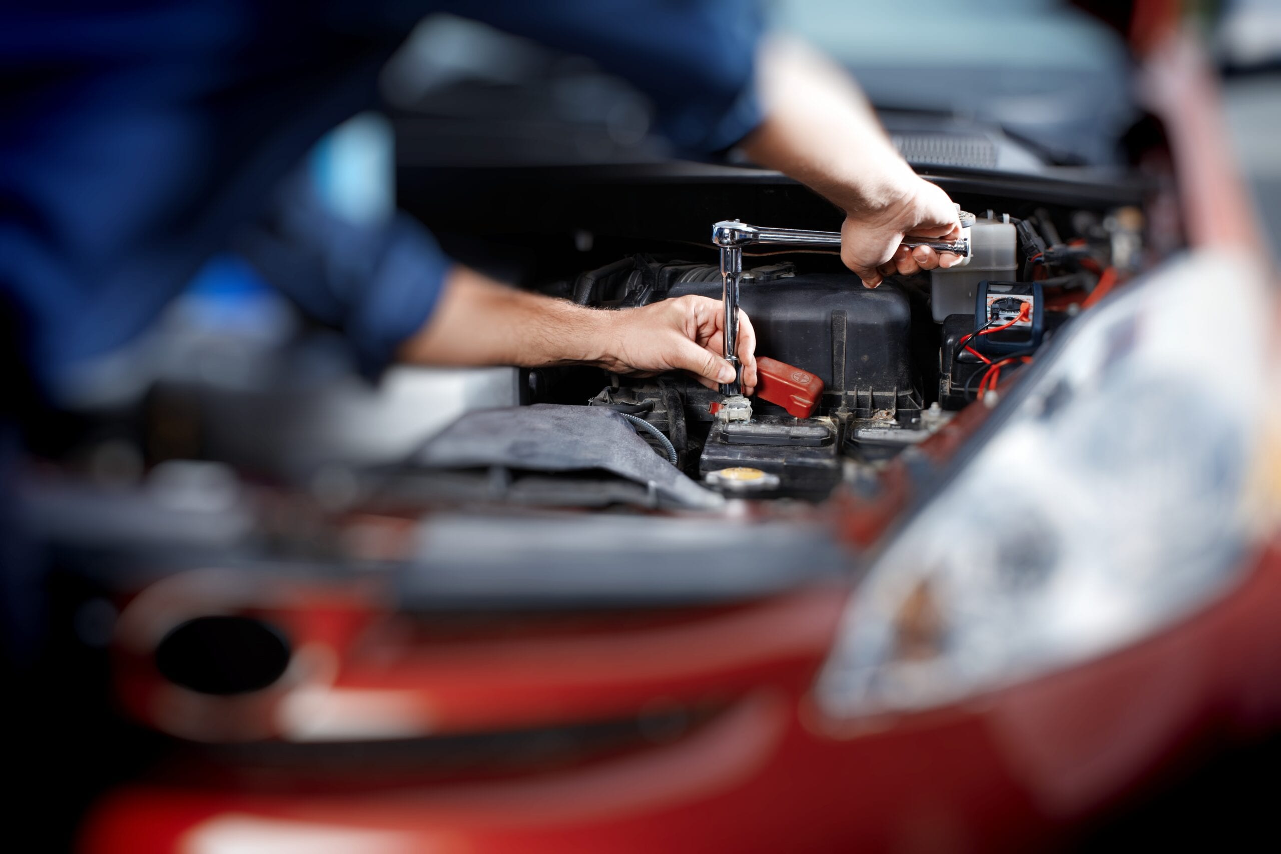 Mechanic working in auto repair garage Mechanic working in auto repair garage. Car maintenance