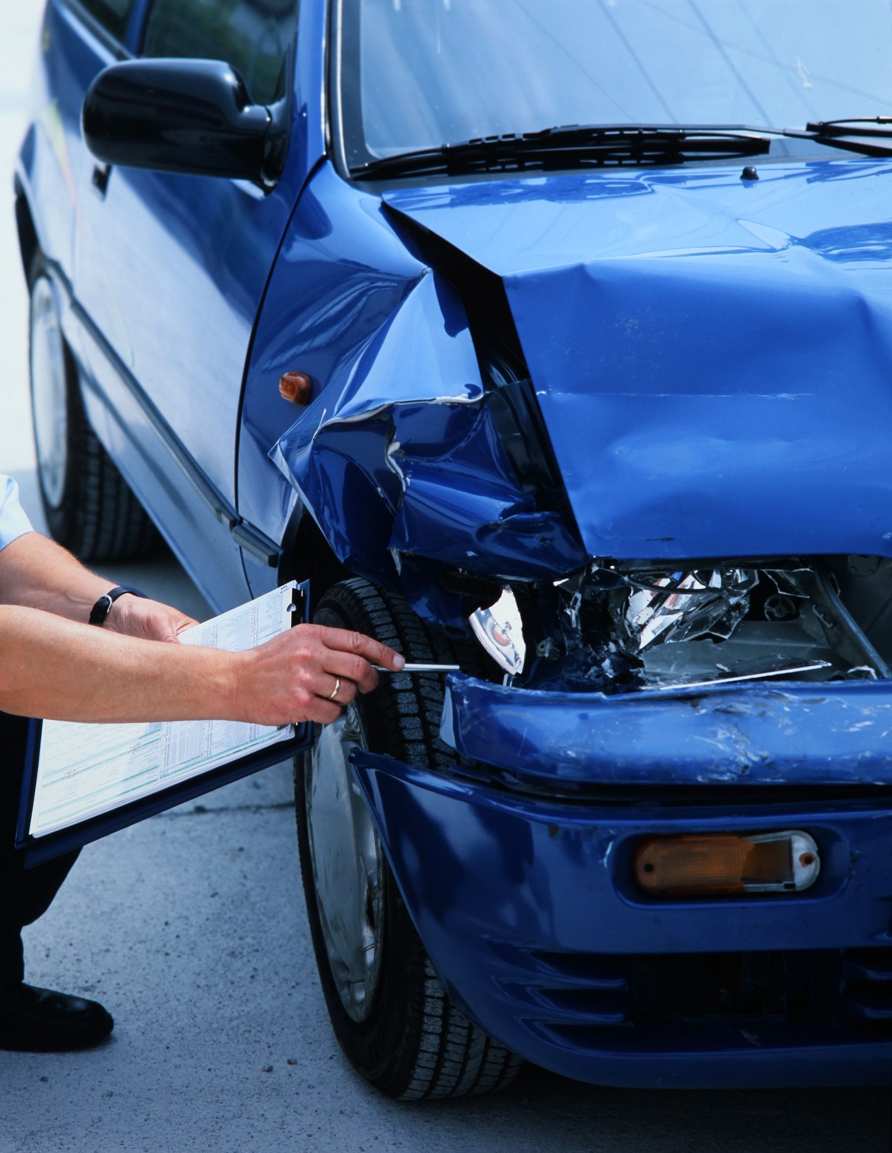  expert evaluating damage on a car